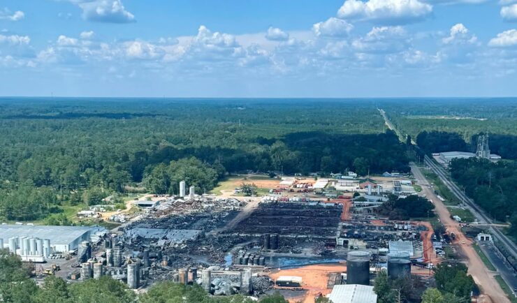 Aerial view of a burned facility surrounded by a woods