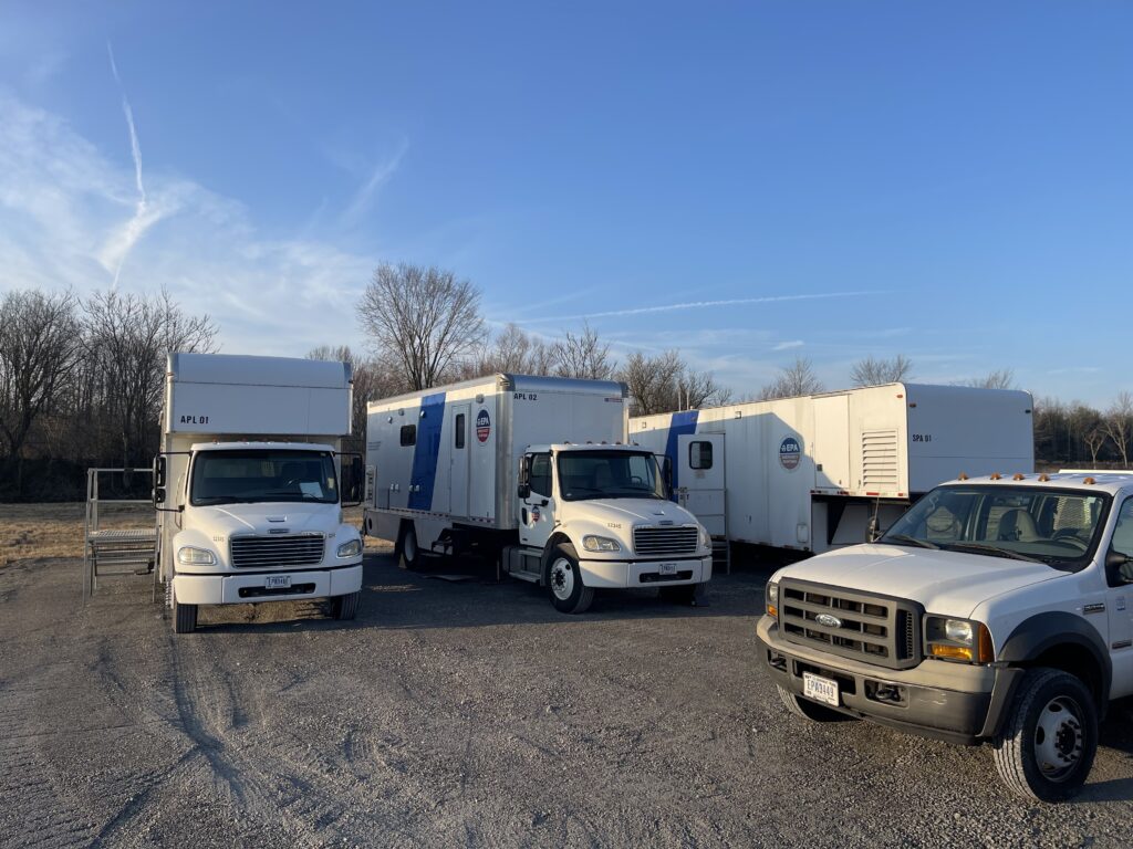 Several mobile lab units in a parking lot