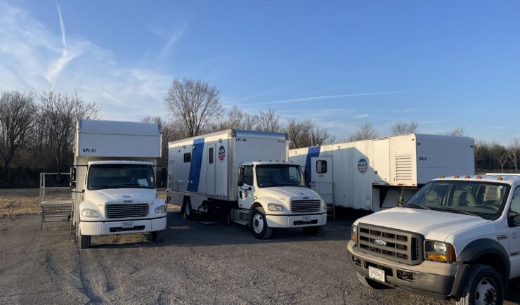 Several mobile lab units in a parking lot