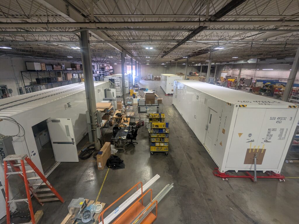 Warehouse with large containers being constructed