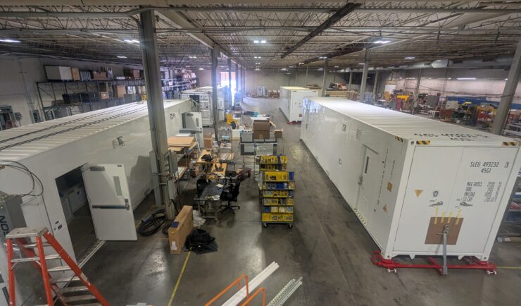 Warehouse with large containers being constructed