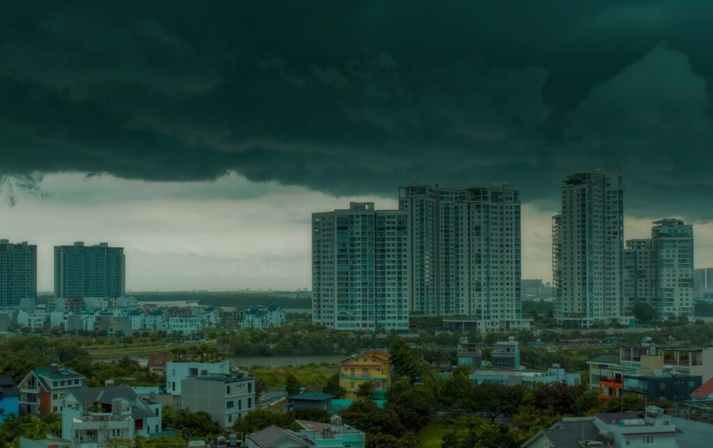 Dark cloud over a city with tall buildings