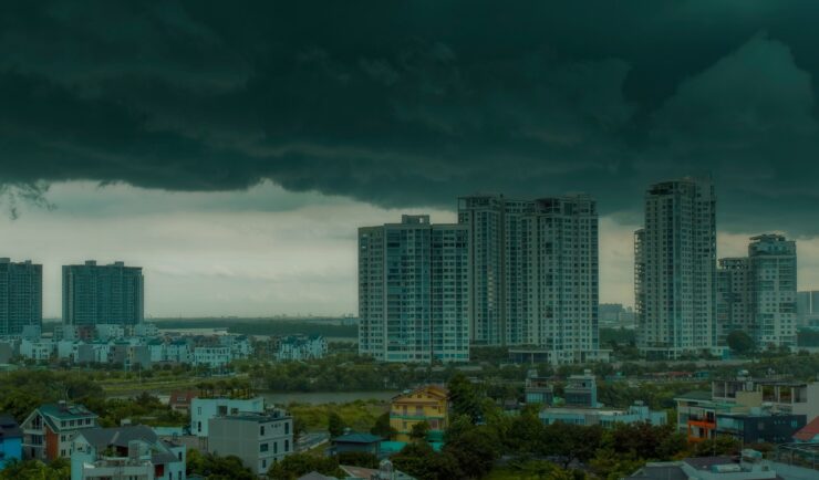Dark cloud over a city with tall buildings