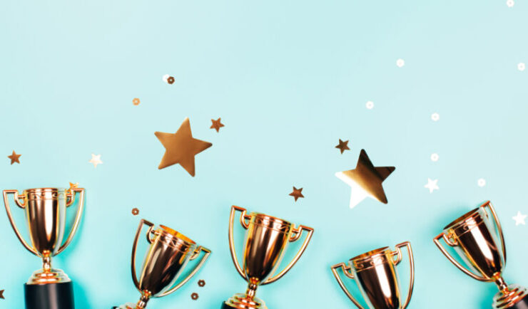 a line of gold trophy cups and stars
