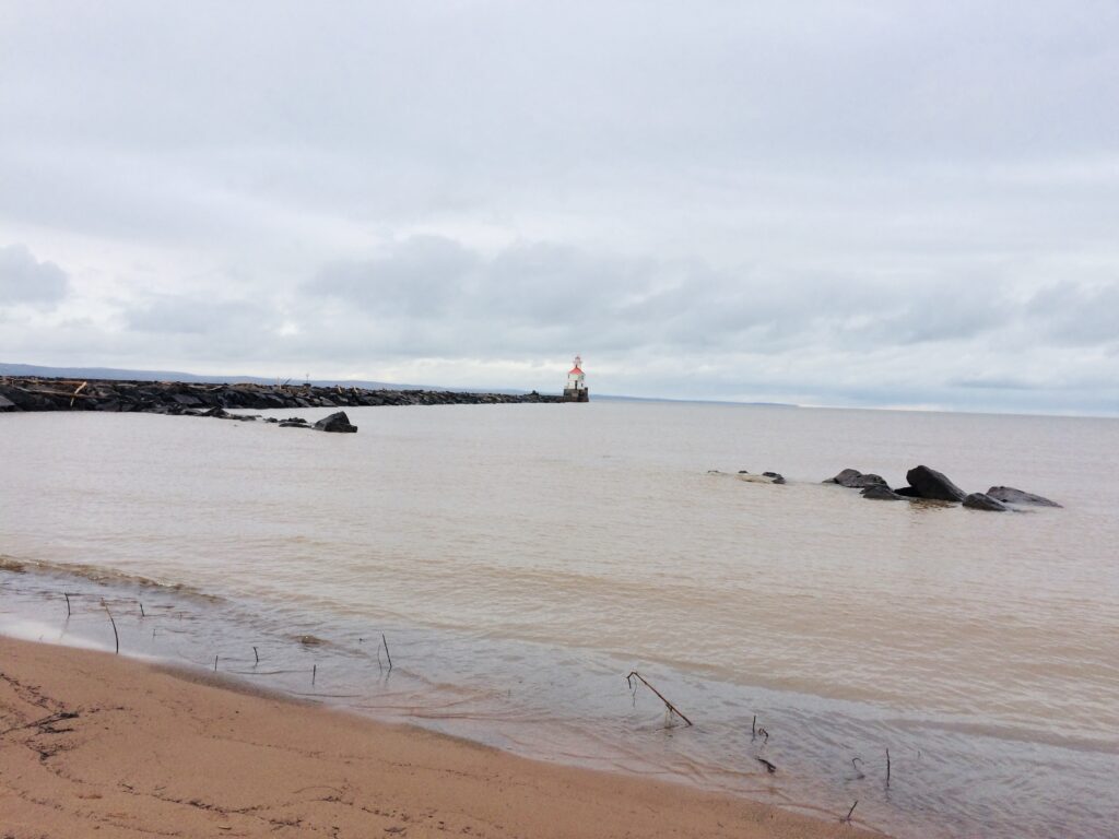 view of lake with a small lighthouse on a jetty