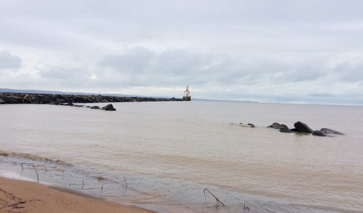 view of lake with a small lighthouse on a jetty